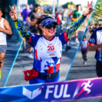 Corredores participan en una edición de la Carrera Atlética Internacional FUL de la UAEH, mientras una atleta celebra con los brazos en alto durante el recorrido por las calles de Pachuca.